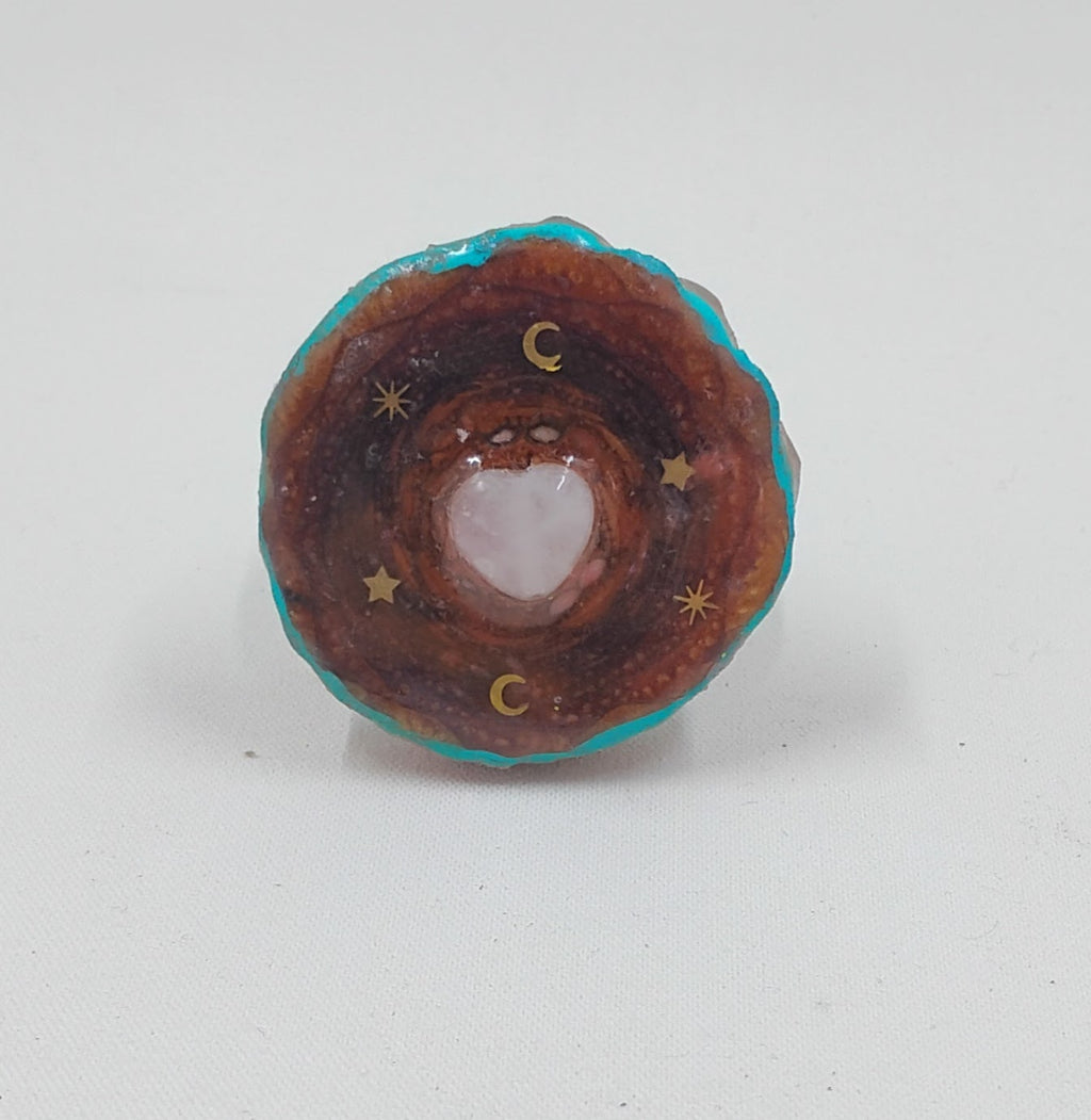 Handcrafted pendant, made out of real pinecone, and added accents of teal, moons, stars and a resin top coat