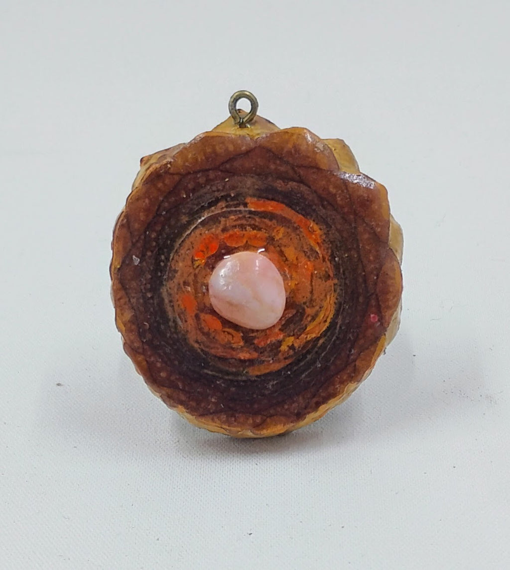 Third Eye pine cone pendant with orange accents and pink rose crystal center.