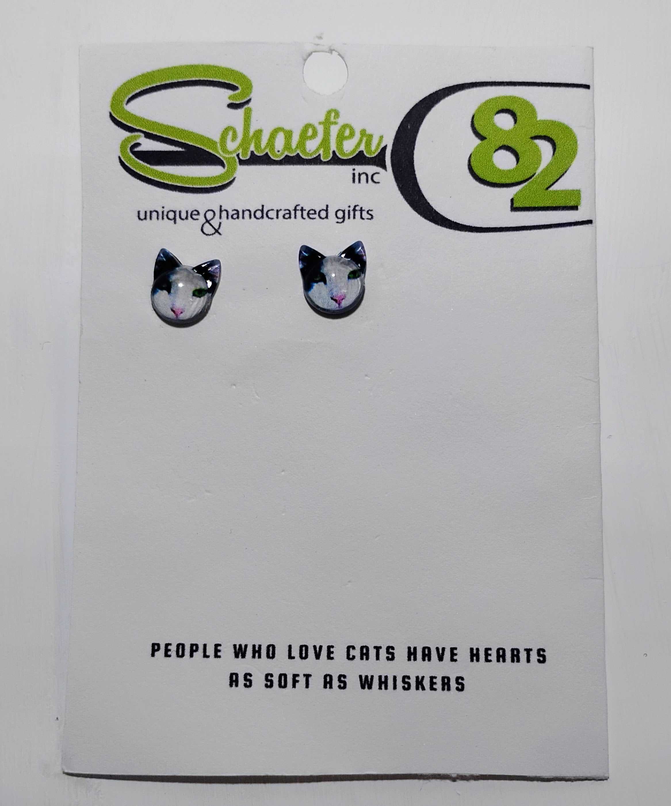 Black and White Cat Stud Earrings featuring a cute cat design on a card with a playful message.