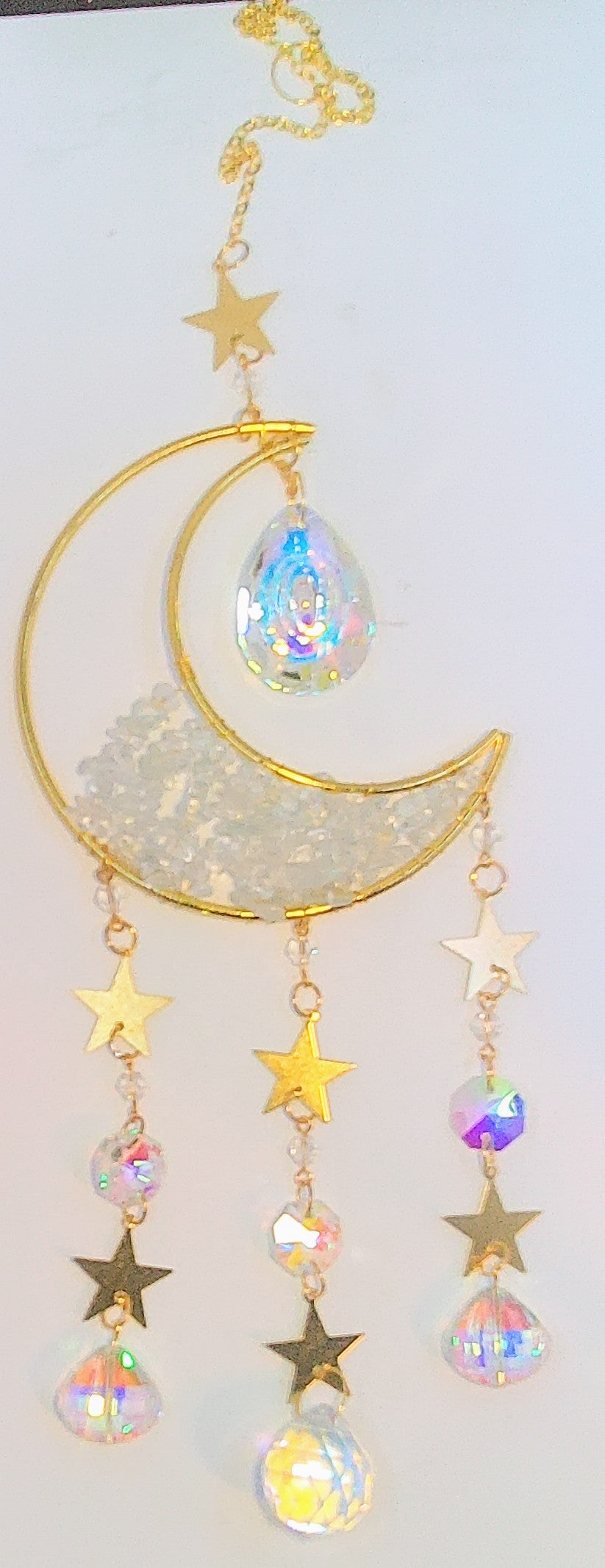 Handcrafted moon sun catcher that is filled half way with clear quartz chip beads and 7 iridescent prism beads. 